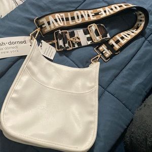 AHDORNED crossbody vegan leather bag with two straps.